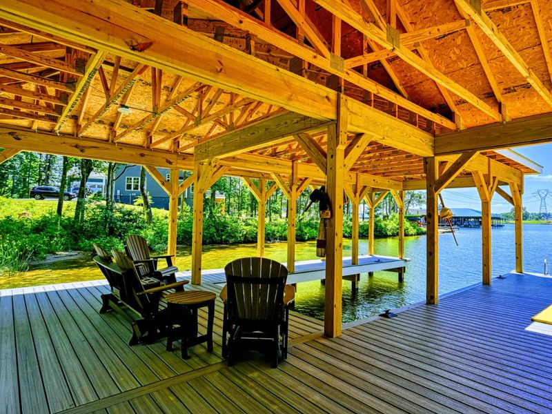 Spacious covered dock with seating area, perfect for relaxing by the water and enjoying the view