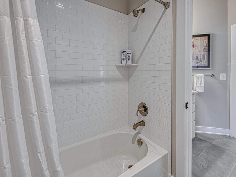 Clean and modern bathroom with a bathtub and shower combo