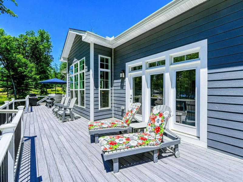 Enjoy the spacious deck with plenty of seating, perfect for outdoor relaxation and dining.