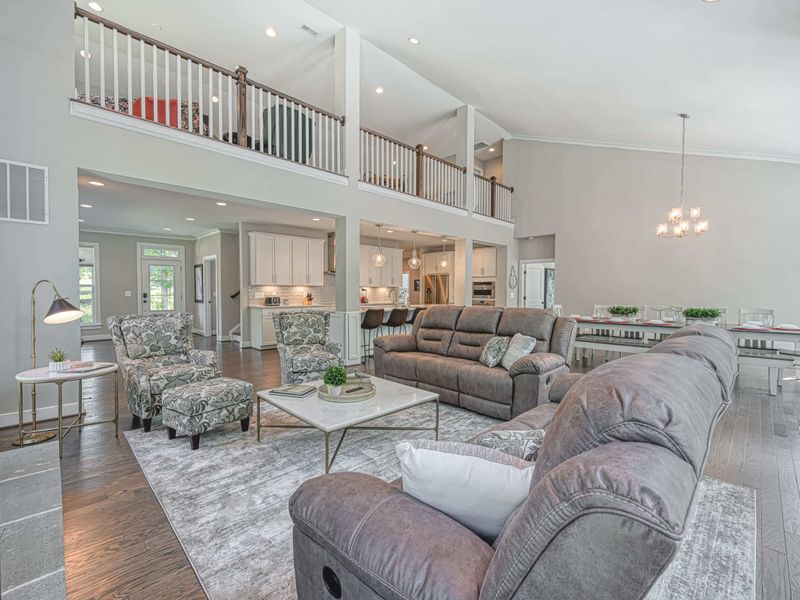 Spacious open-concept living area with comfortable seating, a modern kitchen, and an elegant dining space.