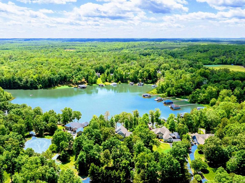 Aerial - Wide drone shot of the Lake Anna cove and surrounding homes nestled among the trees.