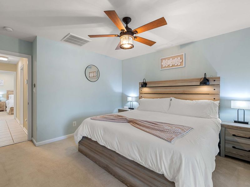 A cozy and stylish bedroom with a king-size bed, warm lighting, and modern decor, offering a peaceful retreat for guests.