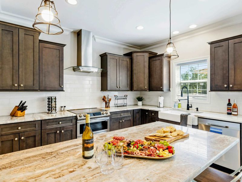 Stylish kitchen with a spacious marble island, perfect for entertaining with a charcuterie board and wine