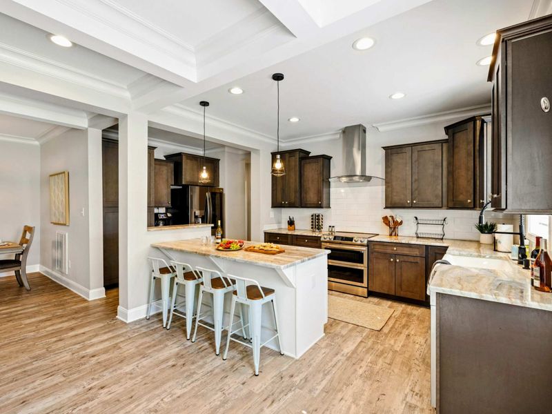 Modern and spacious kitchen with a large island, bar seating, and sleek cabinetry, perfect for cooking and entertaining