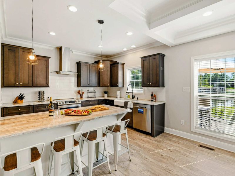 Bright and modern kitchen with an inviting island and bar seating, ideal for casual dining and entertaining