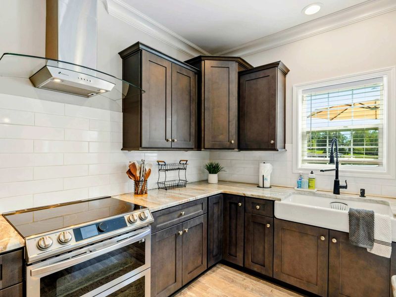 Modern kitchen with sleek cabinetry, stainless steel appliances, and a farmhouse sink, perfect for a gourmet cooking experience