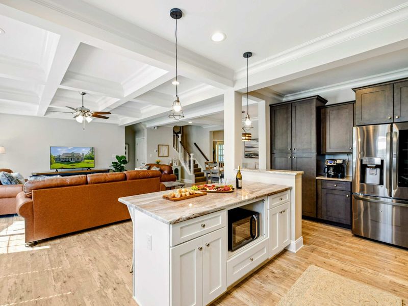 Beautifully designed kitchen with an island that opens to a cozy living room, ideal for entertaining and family time