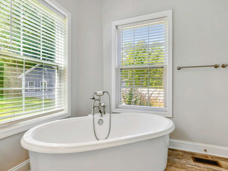 Primary Suite Bathroom - The freestanding soaking tub is the kind you plan your whole evening around.