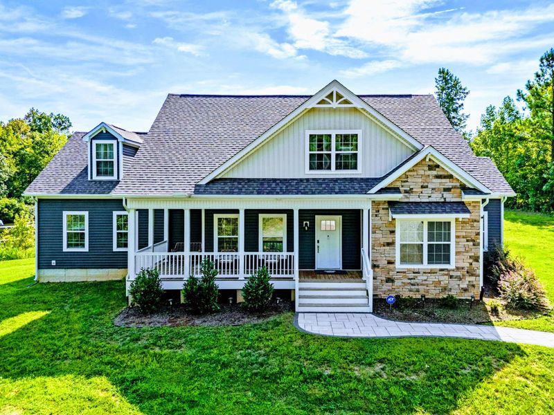 Charming and inviting home with a welcoming front porch, perfect for a relaxing stay