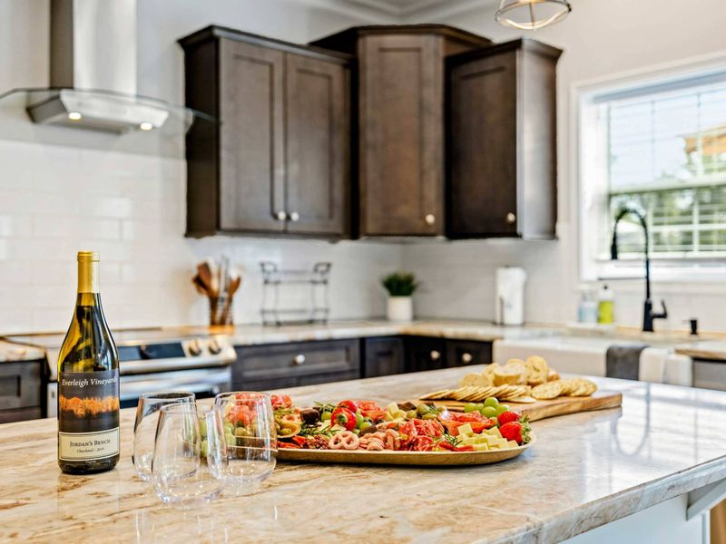 Elegant kitchen island with a charcuterie board and wine, creating a welcoming and gourmet atmosphere