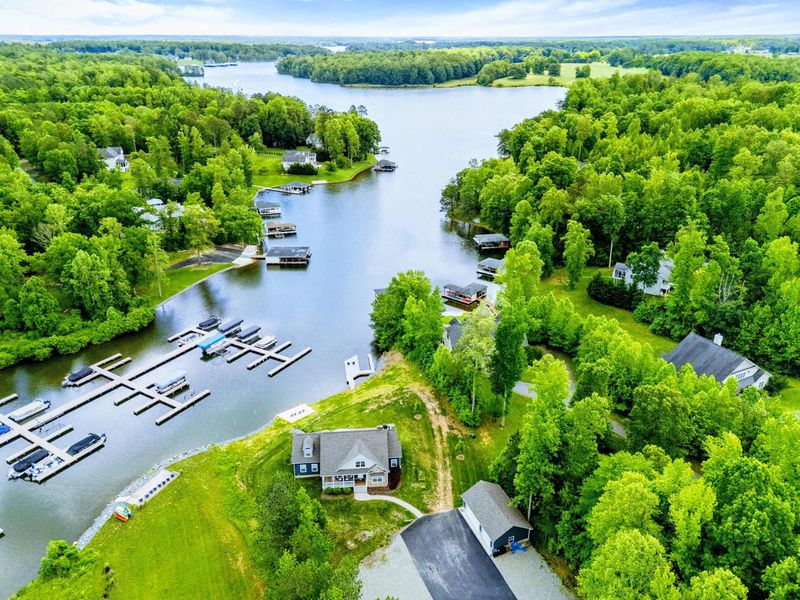 Aerial - Wide drone shot showing the home's position on the cove with the lake stretching into the distance.