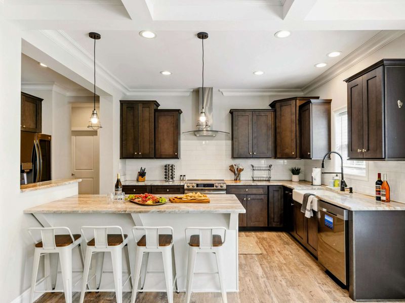 Bright and modern kitchen featuring a large island with bar seating, perfect for casual dining and entertaining