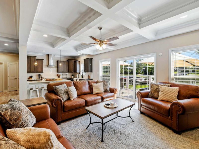 Spacious and beautifully decorated living room with comfortable seating and plenty of natural light