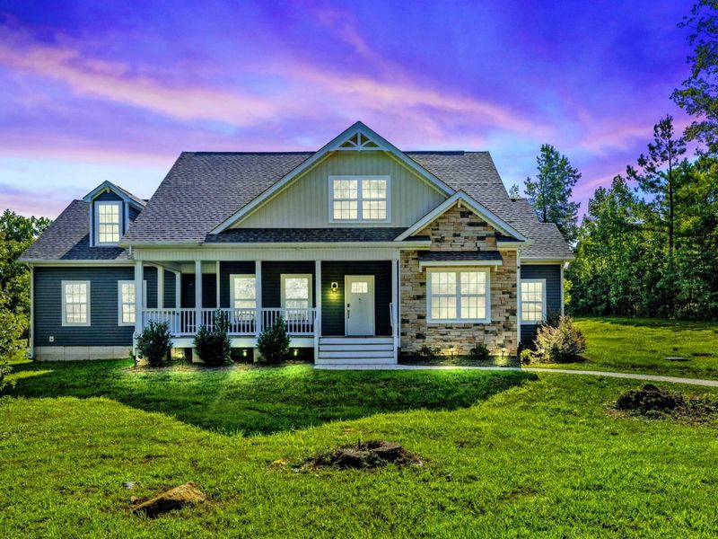 Charming, well-lit home with inviting curb appeal, set against a peaceful evening sky