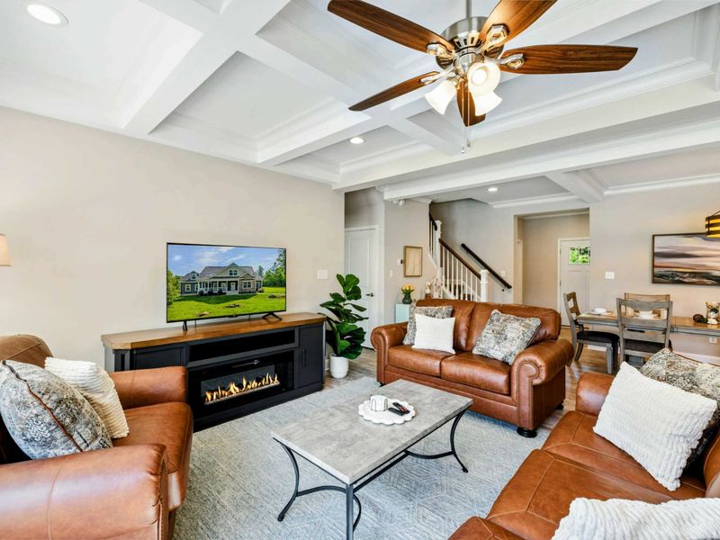 Cozy and elegant living room with a fireplace and modern decor, seamlessly connected to the dining area