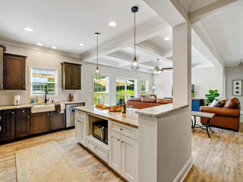 Bright and airy kitchen with a large island and open layout, seamlessly connecting to the living and dining areas
