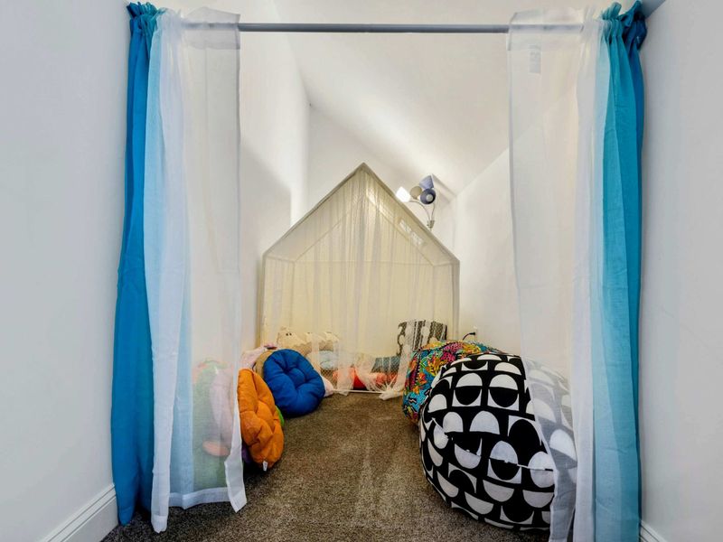 Adorable and cozy play nook with soft seating and a mini tent, perfect for imaginative play