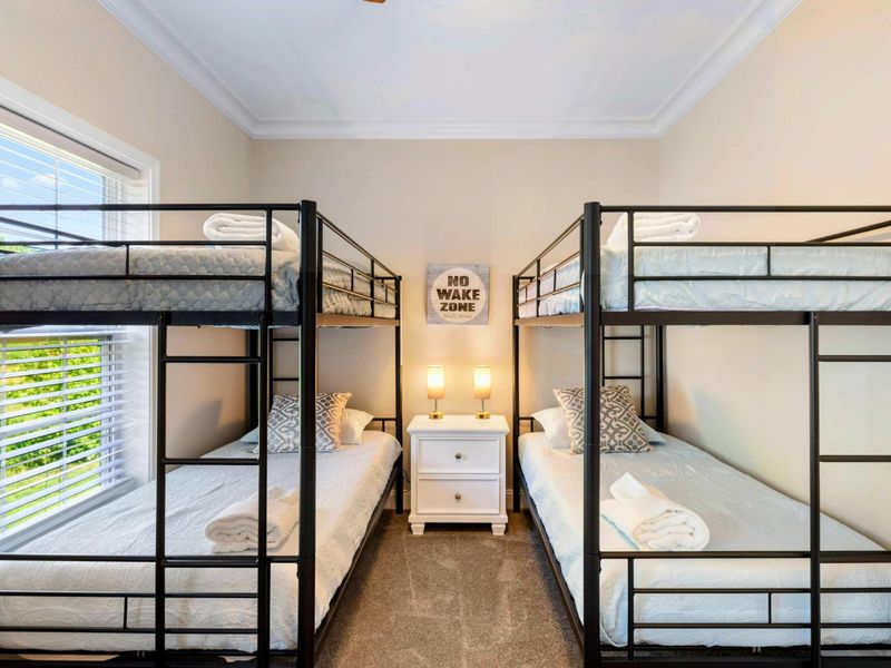 Bunk Room - Two full-over-full bunks with a "No Wake Zone" sign between them, perfect for kids or groups.