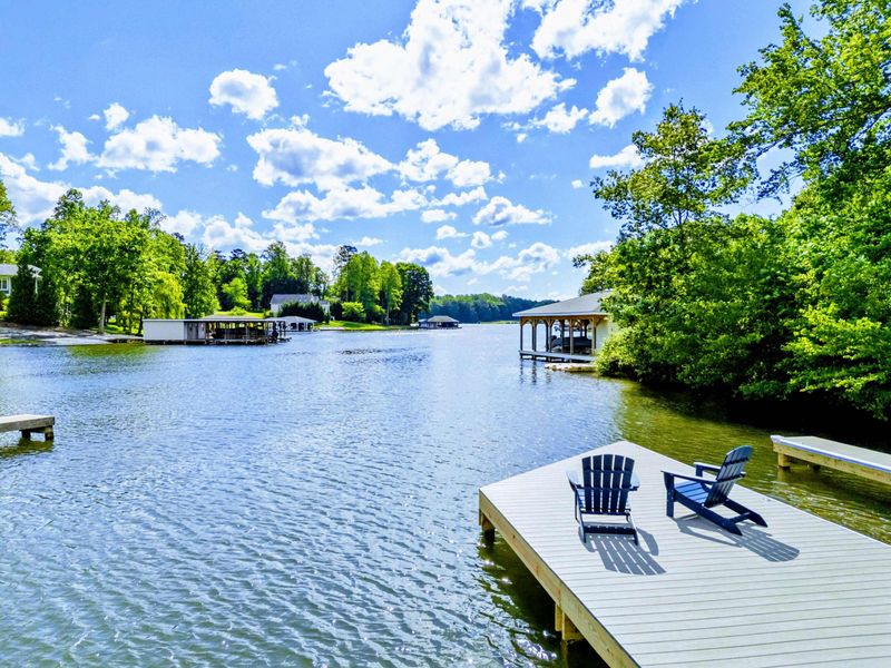 Pause with a View. Chairs turned toward the horizon, this dock invites you to breathe deep and just be.