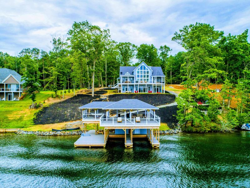 Stunning lakefront home with a spacious double-deck boathouse, offering a luxurious and scenic retreat