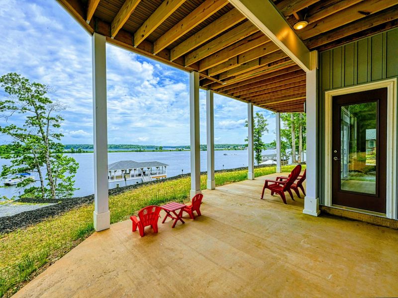 Spacious covered patio with stunning lake views, perfect for families with plenty of space for outdoor fun