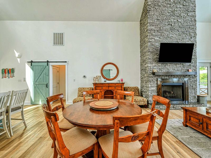 Elegant dining area with a cozy stone fireplace, perfect for enjoying meals and relaxing in a warm, inviting atmosphere
