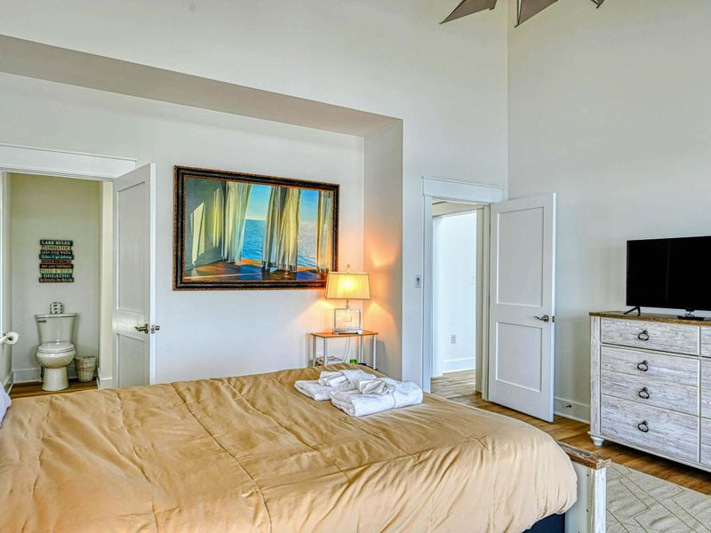 Comfortable bedroom with a connected ensuite, stylish decor, and a TV for relaxing evenings