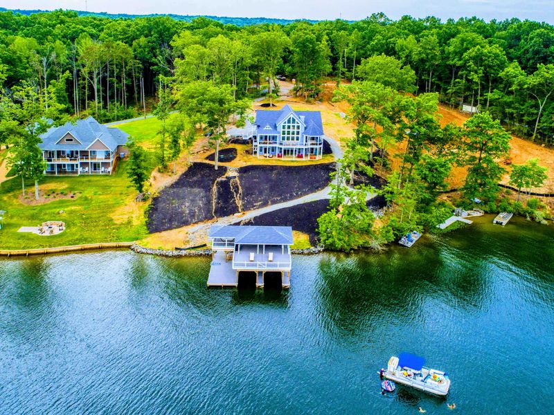 Lakefront property with a private boathouse and dock, perfect for boating enthusiasts seeking a serene waterside escape