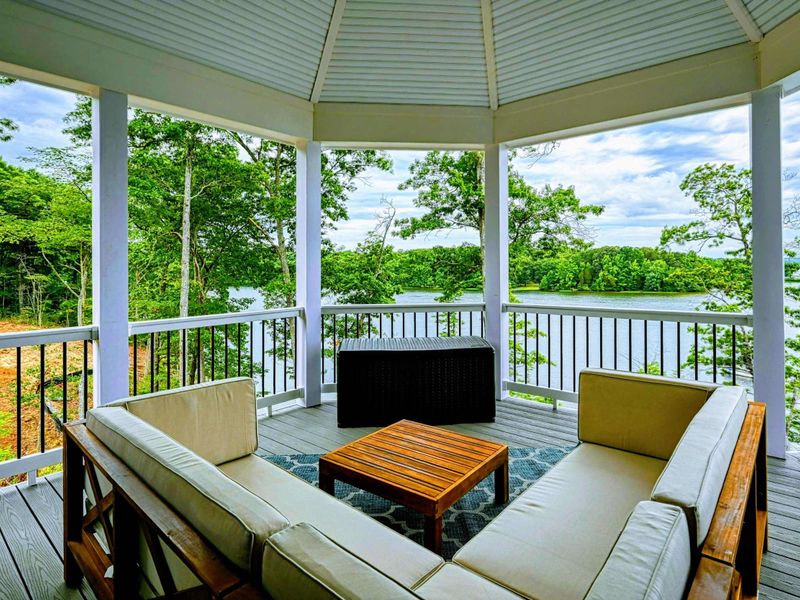 Cozy covered gazebo with comfortable seating and scenic lake views, perfect for enjoying peaceful moments outdoors