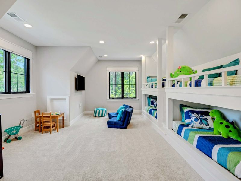 A kids paradise! White wood playhouse, play kitchen/play food and table and chairs. Flip chairs in front of the tv flip down for sleeping.