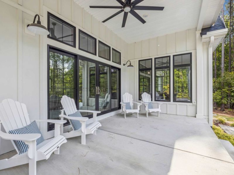 Relax on our spacious covered porch, featuring comfortable Adirondack chairs and ceiling fans, where you can enjoy the fresh air and serene surroundings in total comfort.