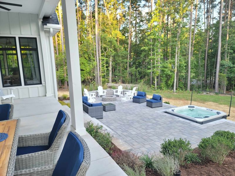 Enjoy our brand new patio featuring a cozy fire pit, a spacious 7-person hot tub, and a dedicated grilling area for the ultimate outdoor experience.
