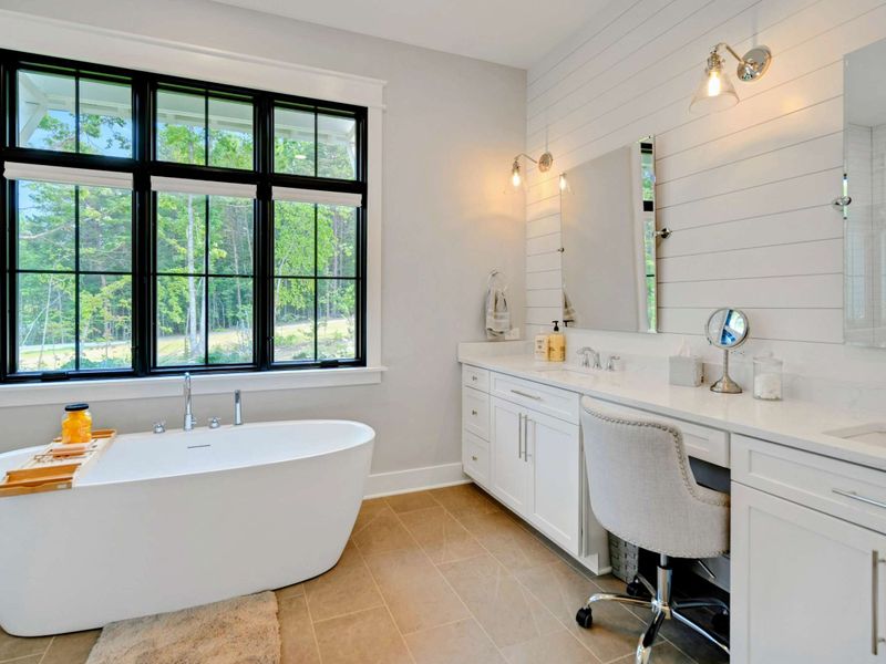 Primary Suite Bathroom with double vanity, soaking tub and large glass shower!