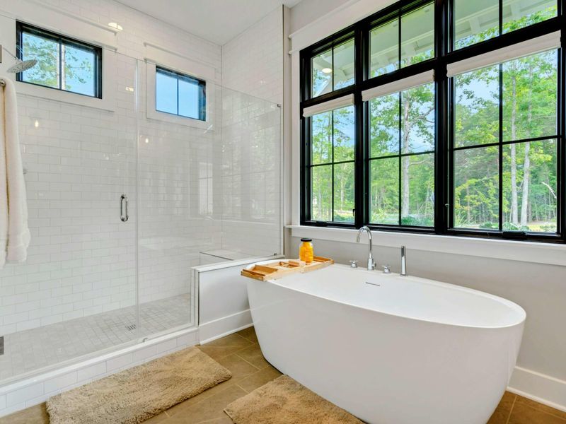 Primary Suite Bathroom with double vanity, soaking tub and large glass shower!