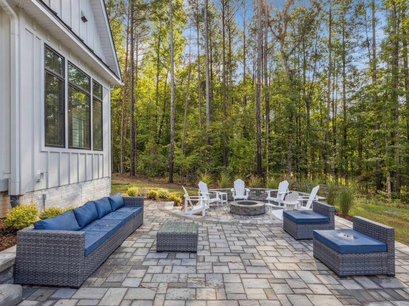 Gather around the fire pit on our spacious patio, surrounded by comfortable seating and the peaceful beauty of nature—perfect for cozy evenings outdoors.