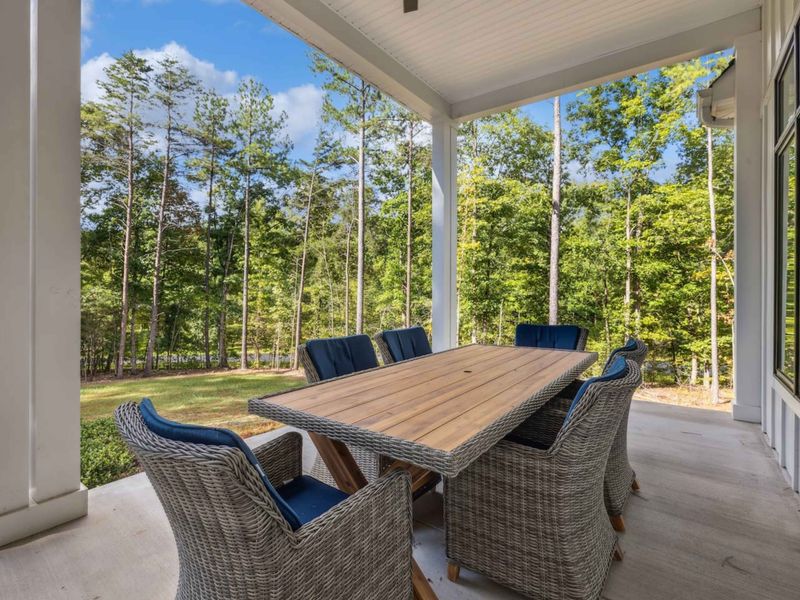 Enjoy dining al fresco on our serene covered patio, surrounded by nature, with comfortable seating perfect for family meals or morning coffee.