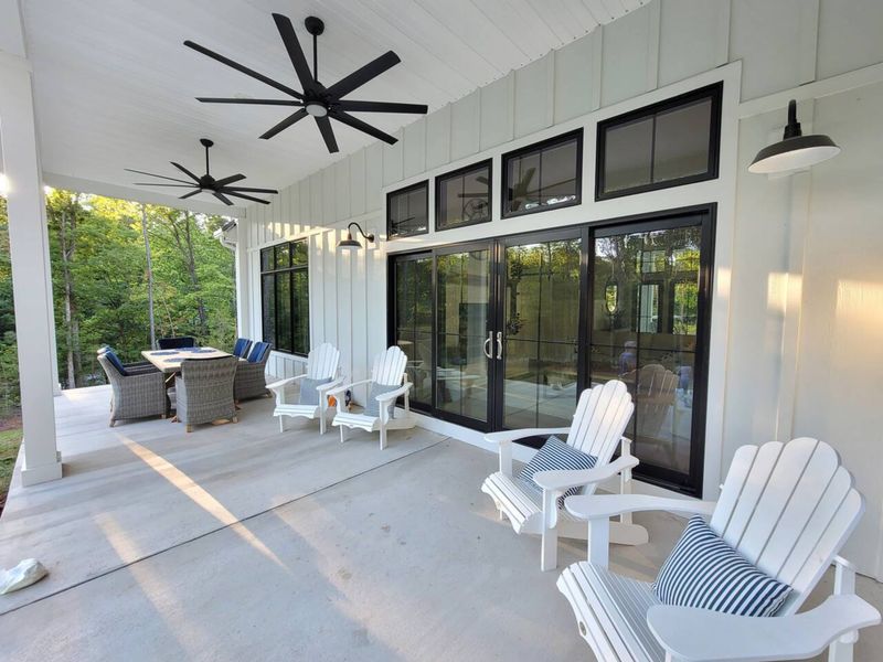 Kick back on our inviting covered porch, complete with cozy seating, ceiling fans, and a spacious dining area—perfect for relaxing or enjoying meals in the fresh air.