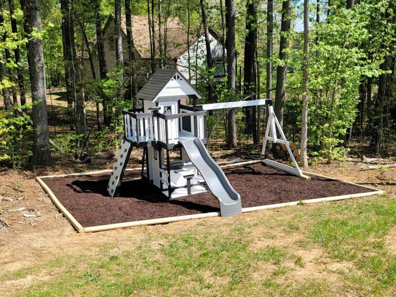 Let the kids enjoy endless fun and adventure on our charming playground, nestled in the shade of the trees for the perfect outdoor playtime.