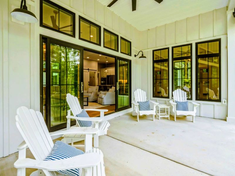 Relax on our spacious covered porch, featuring comfortable Adirondack chairs and ceiling fans, where you can enjoy the fresh air and serene surroundings in total comfort.