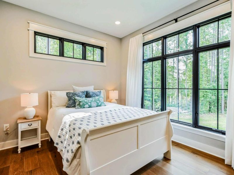 Main level queen guest room with jack and jill full bath.