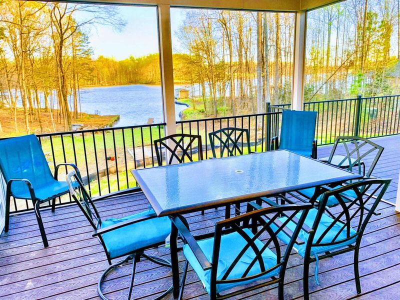 Screened Porch - Long dinners and card games with the lake in view and not a bug in sight, the easy heart of the outdoor living.
