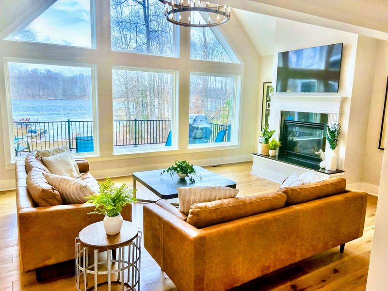 Great Room - Leather sofas, a wall of windows, and the lake right there, the room where the whole group naturally gathers.