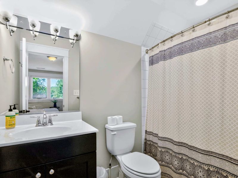 Suite 4 Bath - Compact, well-lit, and ready for the next round of post-swim rinses.