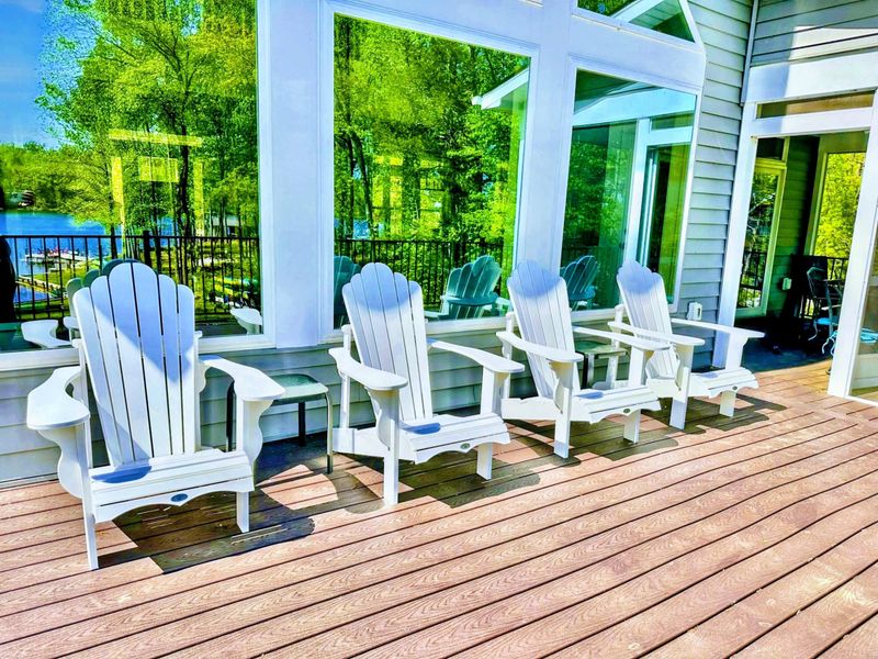 Deck - White Adirondack chairs line the sunny deck, the front-row perch for morning coffee and an afternoon watching the water.