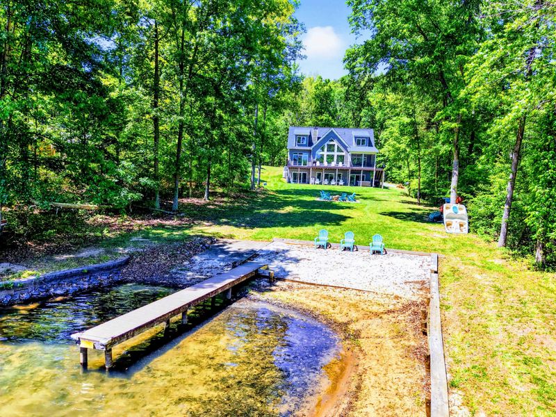 Backyard - The full view from the water: private beach, dock, and a house with the lake square in its sights.