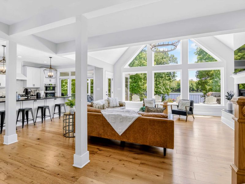 Great Room - A-frame wall of glass framing the lake, kitchen and living flowing together so nobody misses the view.