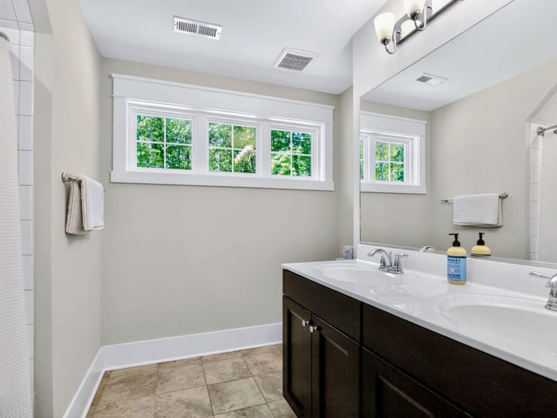 Suite 5 Bath - Double vanity with bright transom windows above, plenty of room for two to get ready at once.