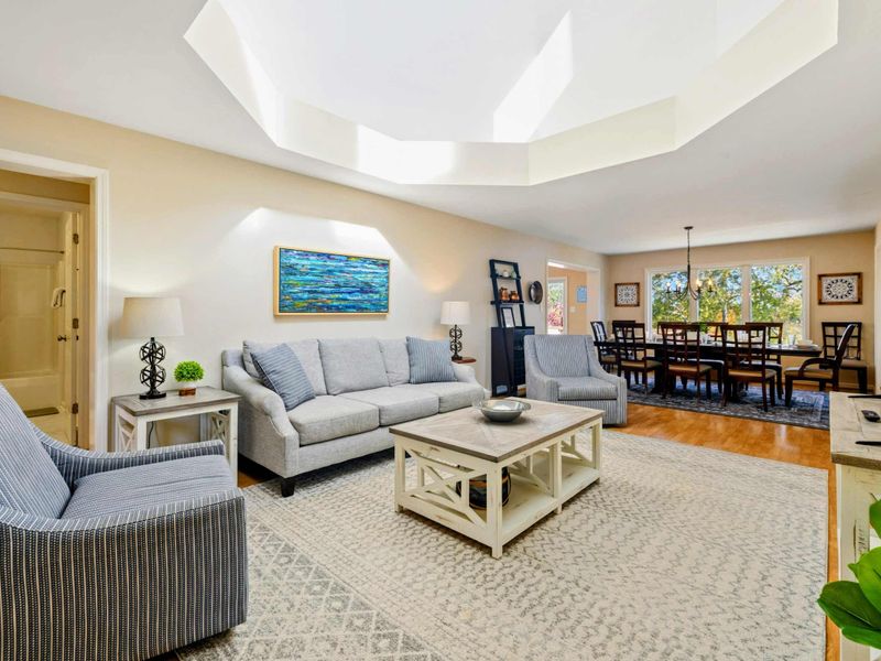 Spacious and bright living area with comfortable seating, open layout, and tasteful decor