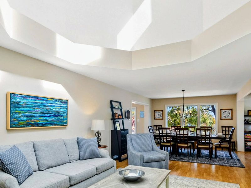 Cozy living area with stylish furnishings and an open view into the inviting dining space