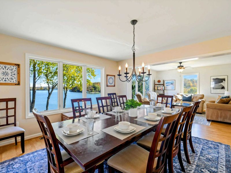 Elegant dining area with lake views, adjoining a cozy sitting room for a relaxing atmosphere